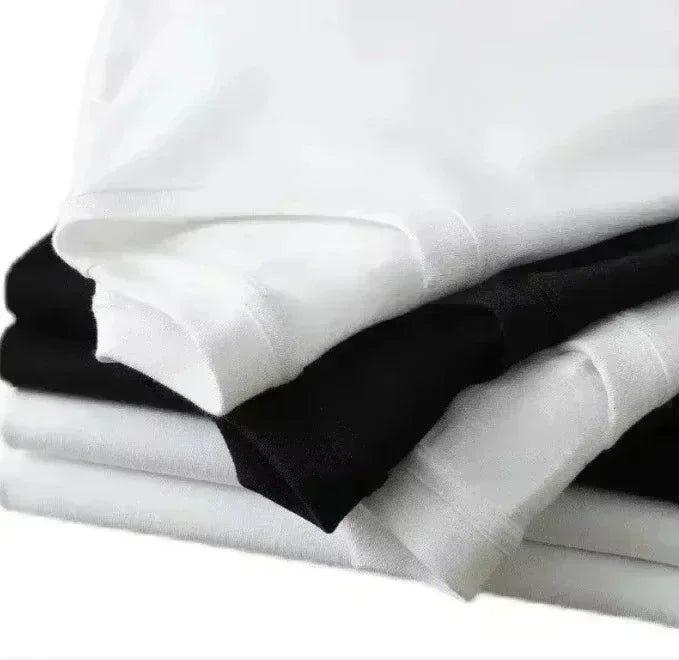 Stack of neatly folded white and black pure cotton loose t-shirts with american hip hop printed versatile short sleeves