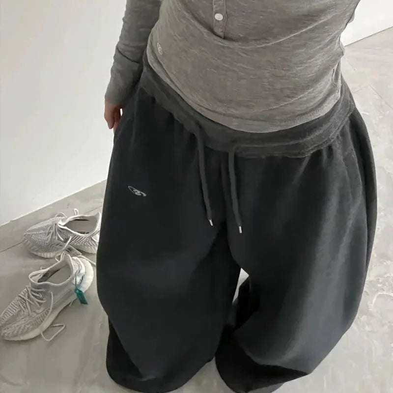 Black casual sweatpants with wide-leg design, drawstring waistband, and subtle logo for jogging pants high streetwear