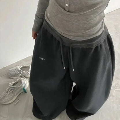 Black casual sweatpants with wide-leg design, drawstring waistband, and subtle logo for jogging pants high streetwear