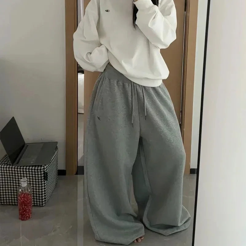 Gray wide-leg sweatpants with drawstring waistband feature soft fabric for comfortable jogging pants high in korean streetwear style