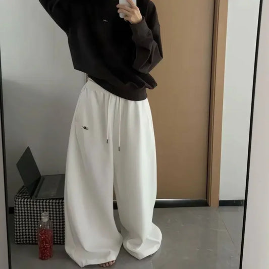 White wide-leg sweatpants with drawstring waist and embroidered eye detail in american retro korean streetwear style
