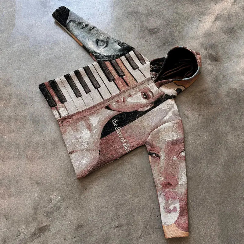 A y2k style hoodie featuring a surreal collage of faces and piano keys in muted tones with the diary of alia text