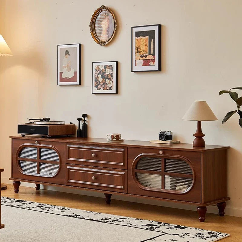 Warm brown wooden vintage tv stand with oval glass-paneled doors and two drawers in mid century aesthetic cabinet classic luxury