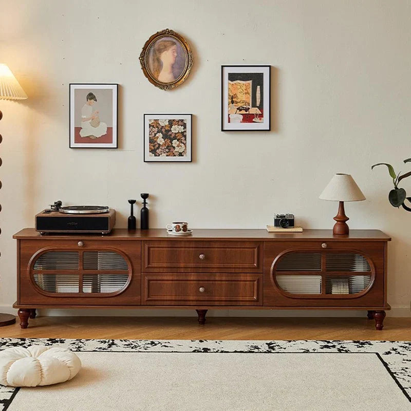 A warm-toned wooden vintage tv stand with oval glass doors and drawers featuring a mid century aesthetic and cabinet classic luxury