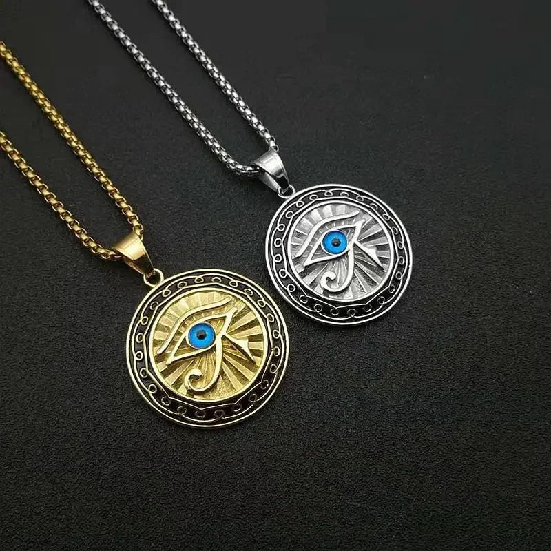 Two circular ancient egyptian mythology horus pendant necklaces in gold and silver tones with blue center stones