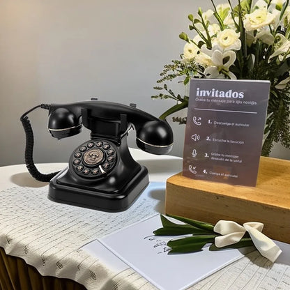 Black vintage rotary telephone with glossy finish and silver accents used as antique wedding audio tape recorders message device