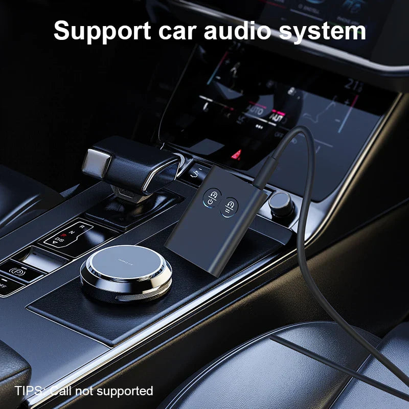 Black rectangular aptx-adaptive stereo music multipoint wireless adapter with two buttons and 3.5mm cable on console