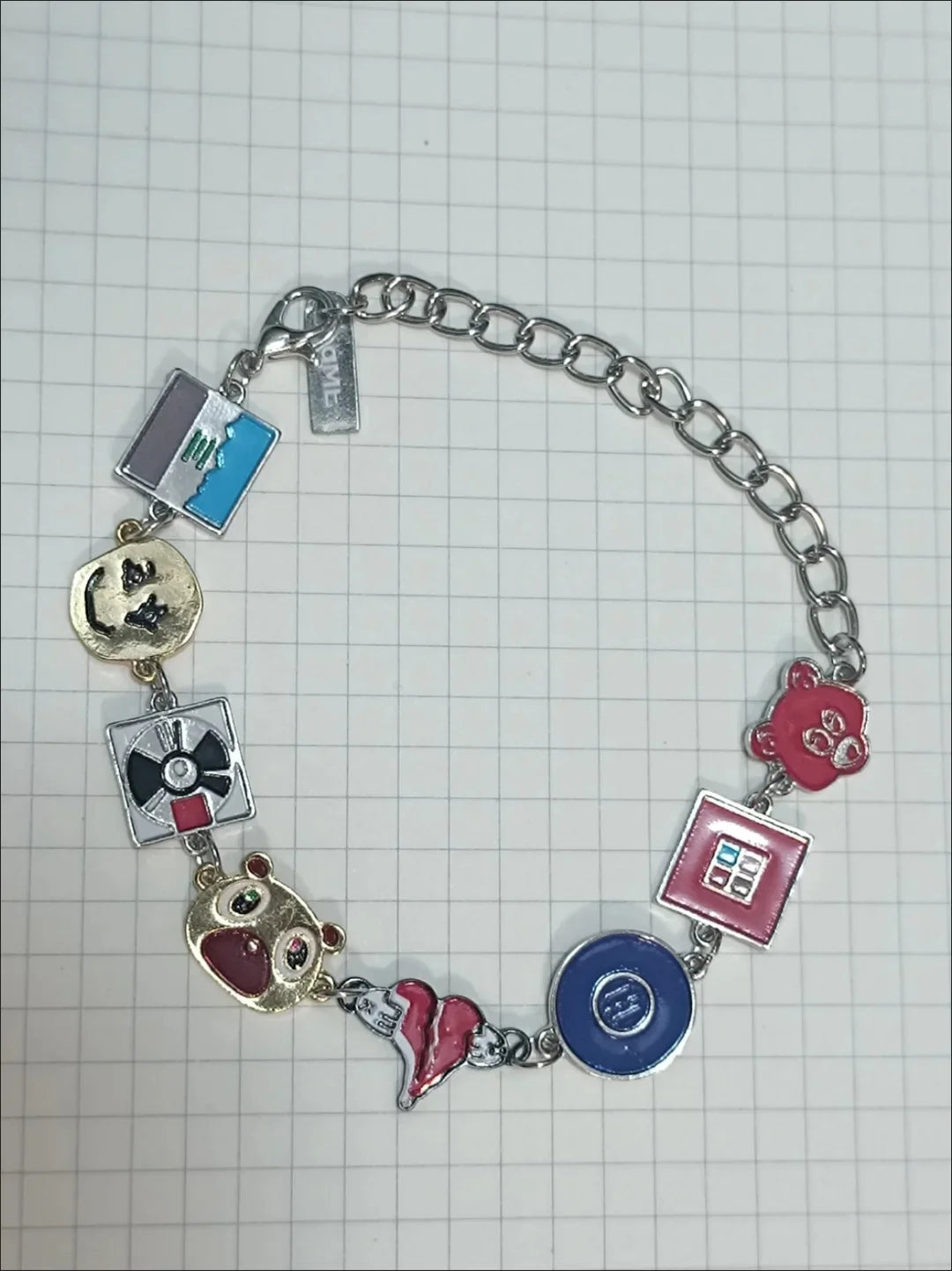 A silver metal cuff bangle bracelet with colorful enamel charms featuring cartoon characters in album bracelets kawaii style