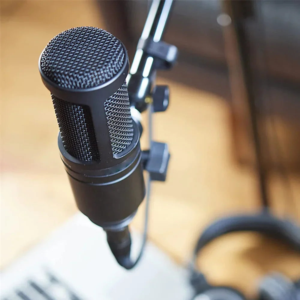 Black at2020 cardioid condenser microphone with mesh grille and metallic accents on stand for recording gaming live and studio applications mic
