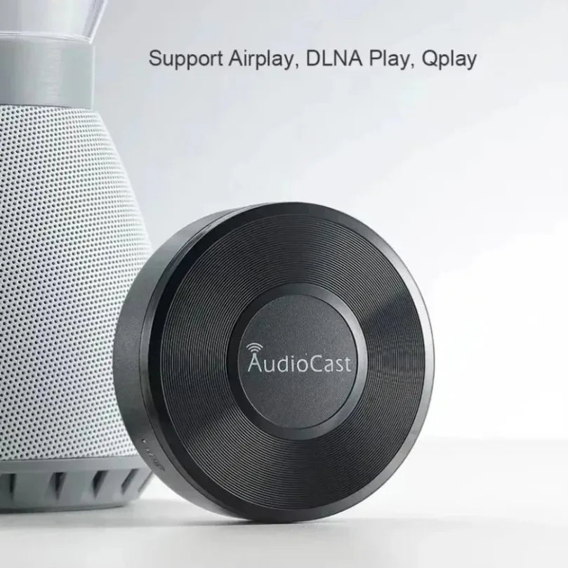 Black circular audiocast wireless dlna airplay adapter with textured surface and central logo for spotify streamer use