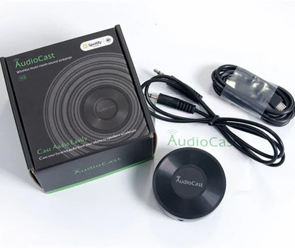 Black circular audiocast m5 wireless music audio streamer with matte finish and central logo for airplay audio music use
