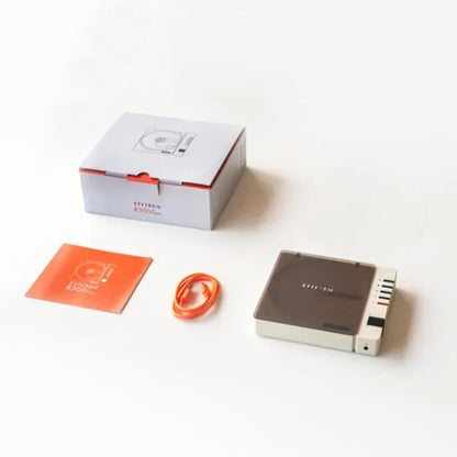 Gray and white sylvan b300 audio interface with orange cable and packaging for quality wireless bluetooth use