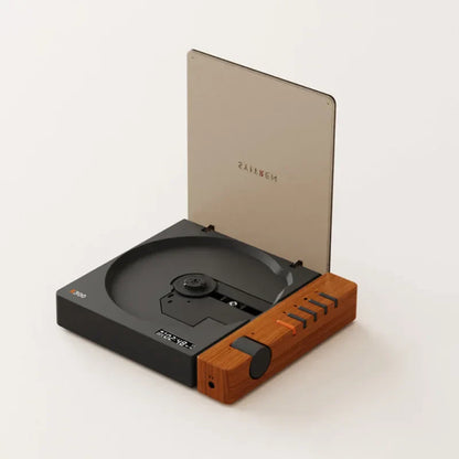 A sleek black and wood-grain portable cd player with transparent lid and orange buttons featuring quality wireless bluetooth