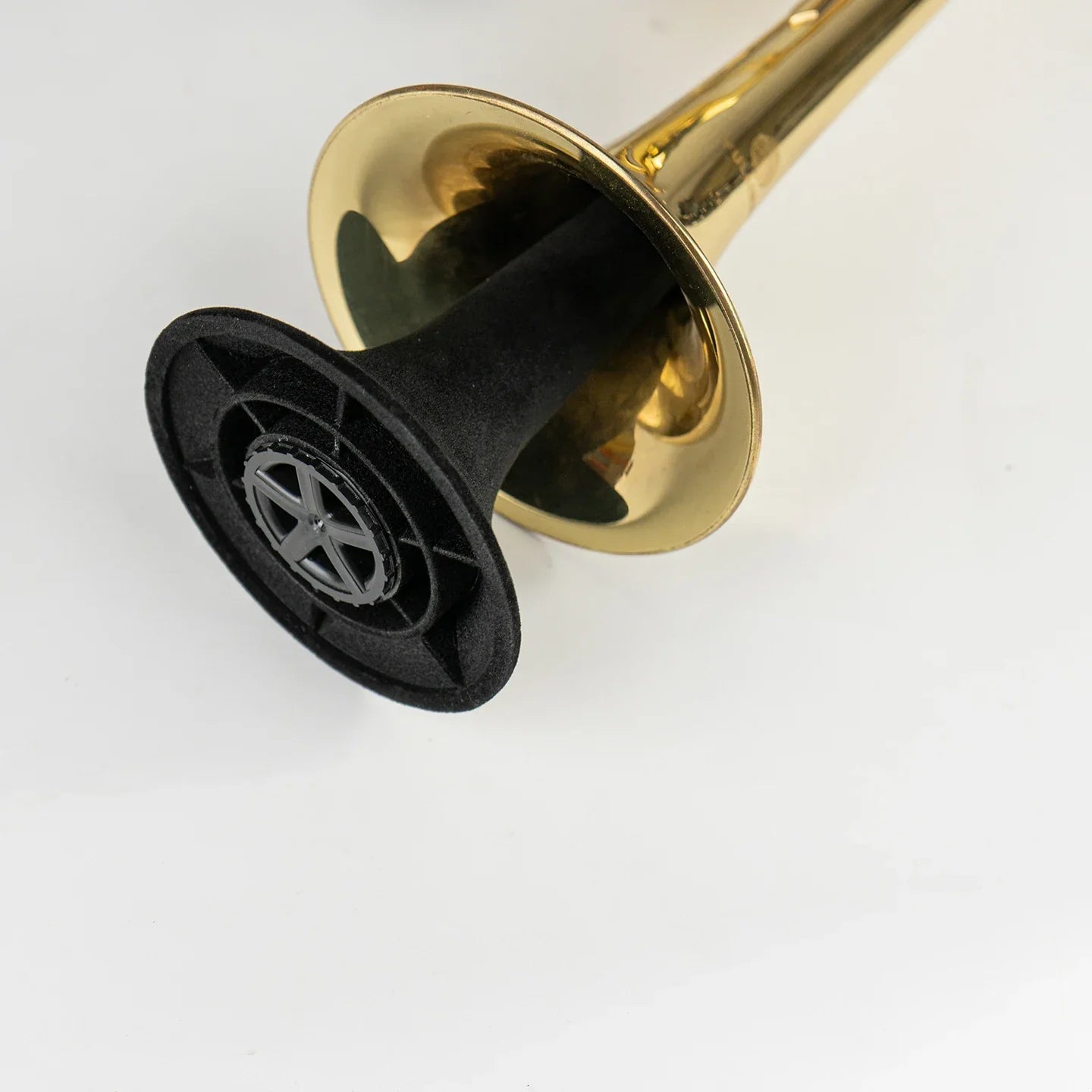 Gold-colored brass horn with a black plastic base featuring a silver star emblem for a stand portable foldable trumpet instrument stand