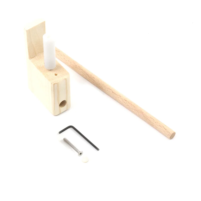 Light-colored wooden pencil sharpener with white insert and matching dowel in ba-guitar bridge tool set for musical instrument manufacturing