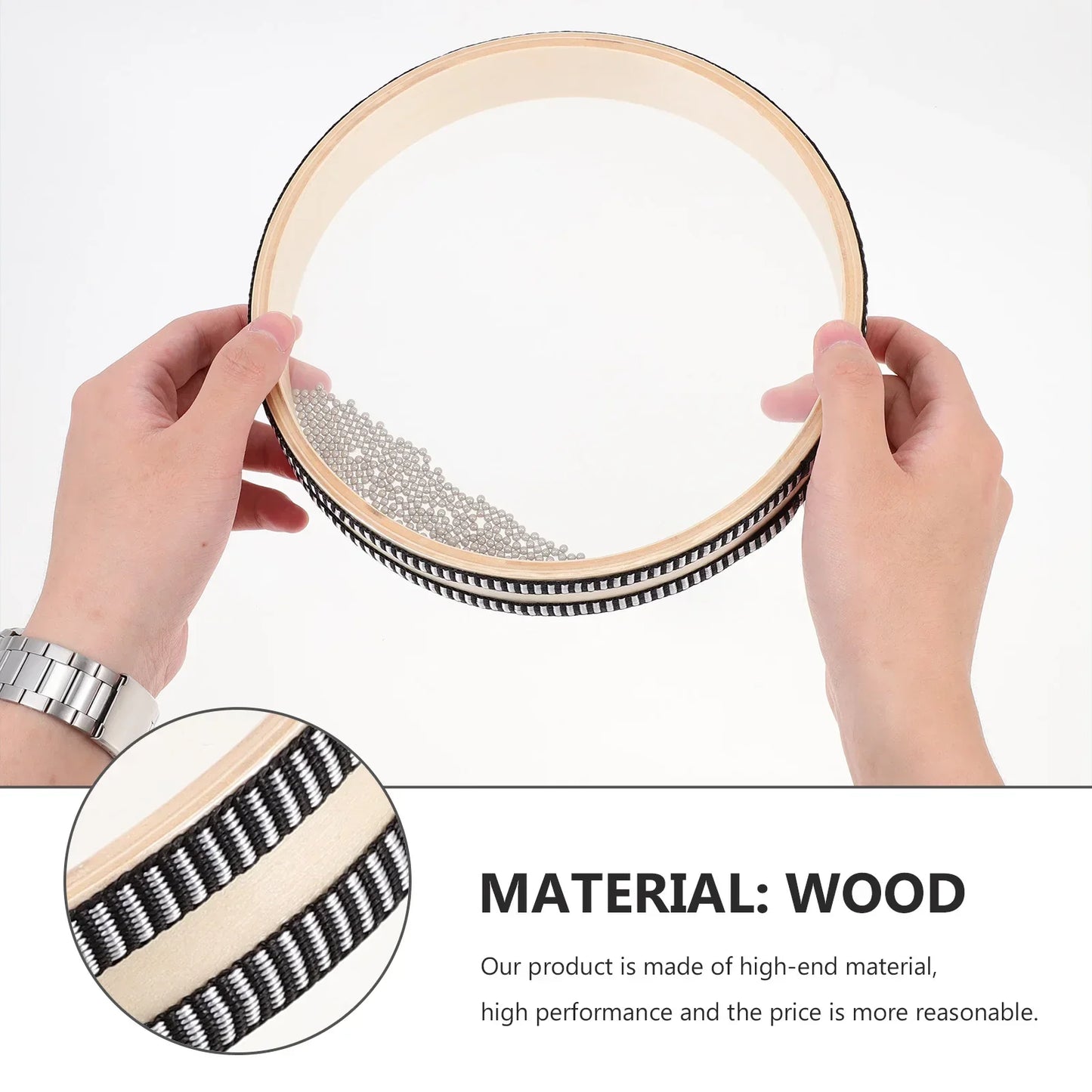A round wooden baby montessori ocean bead hand drum with black and white trim filled with small metallic beads for toys early learning