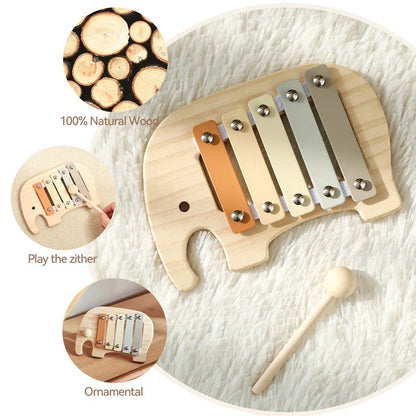 A baby montessori toy cartoon elephant percussion xylophone with natural wood keys in beige orange and silver tones