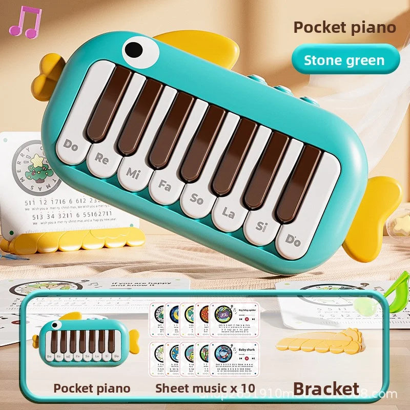 Stone green fish-shaped pocket piano with white and brown keys labeled with musical notes for baby music instruments toy learning educational use