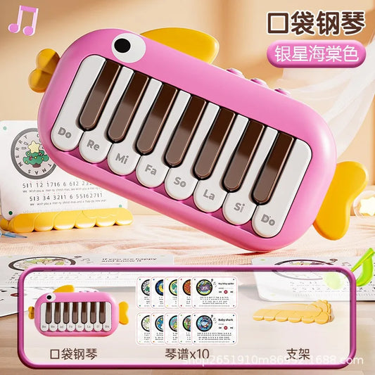 Pink fish-shaped pocket piano with white and brown keys labeled with musical notes for baby music instruments toy learning educational use