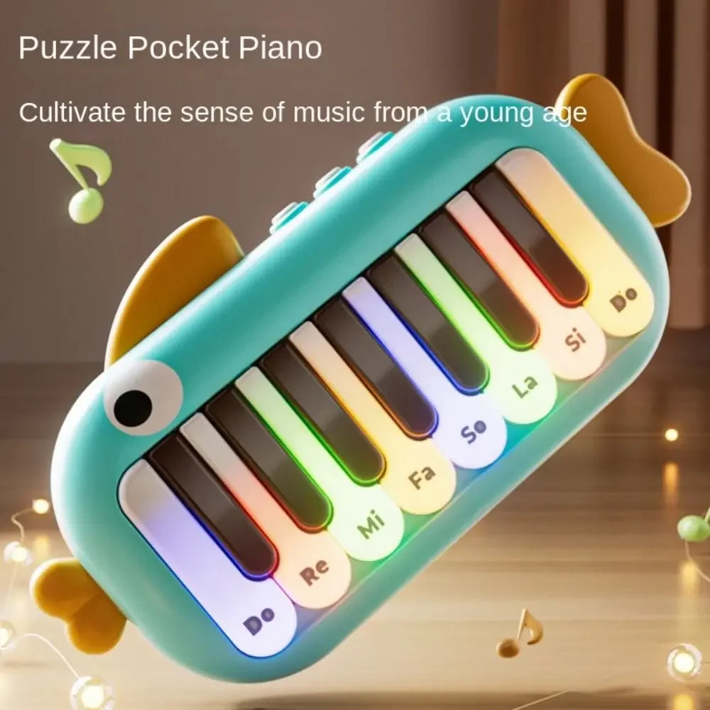 Turquoise fish-shaped baby music instruments montessori electronic pocket piano with colorful illuminated keys and yellow fins