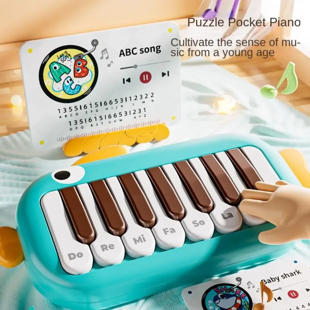 A turquoise plastic baby music instruments montessori pocket piano with brown and white keys and playful googly eyes