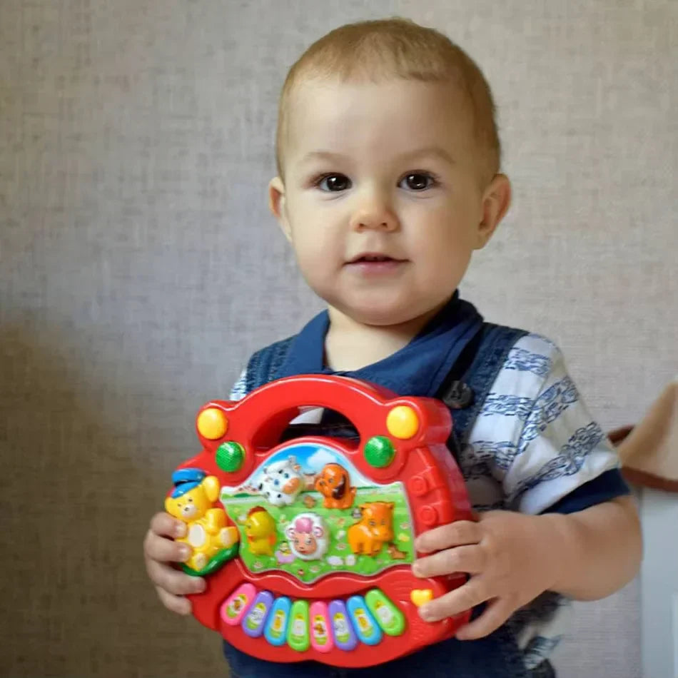 Red plastic baby musical toy kids piano keyboard with colorful animal sound buttons and handle for early educational use