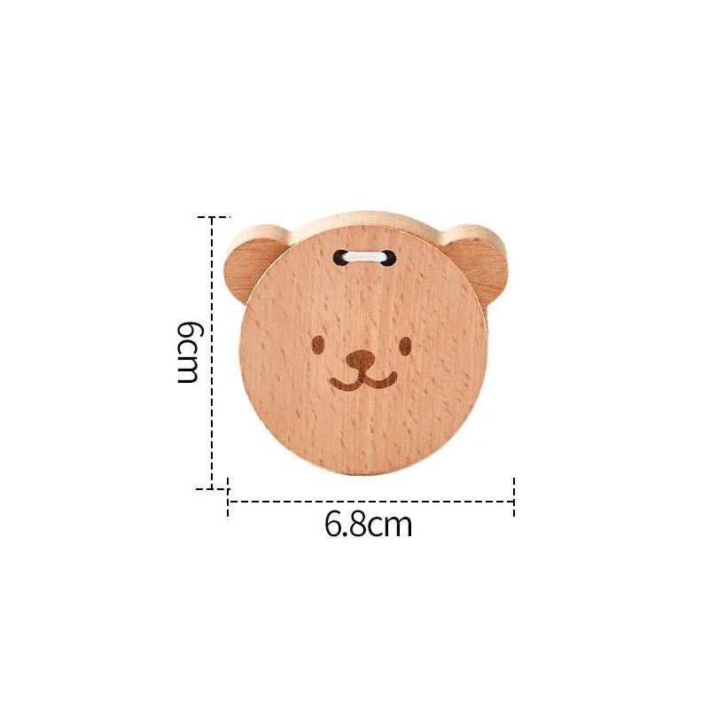 A light brown wooden bear rattle keychain with a simple carved face for baby musical toys and educational instrument playthings