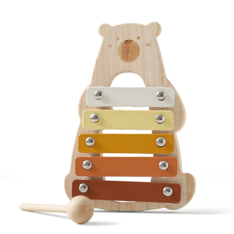 A wooden montessori toy cartoon animal xylophone with five colorful bars in white yellow orange and brown tones for babies