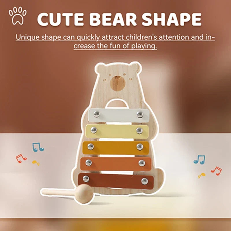 Cute bear-shaped wooden baby percussion music toy with colorful yellow to brown bars and matching mallet for early education