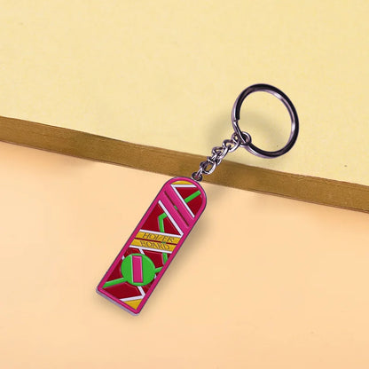 Pink enamel mcfly hoverboard keychain shaped like delorean doppler board with green and yellow accents fun accessory