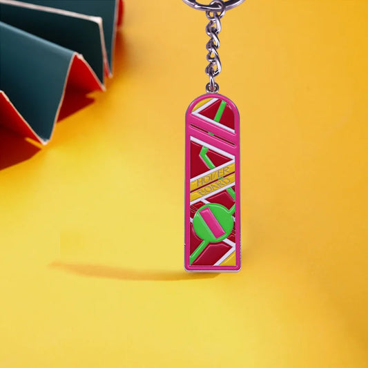Vibrant pink and red enamel marty mcfly hoverboard keychain with green accents and gold lettering fun accessory