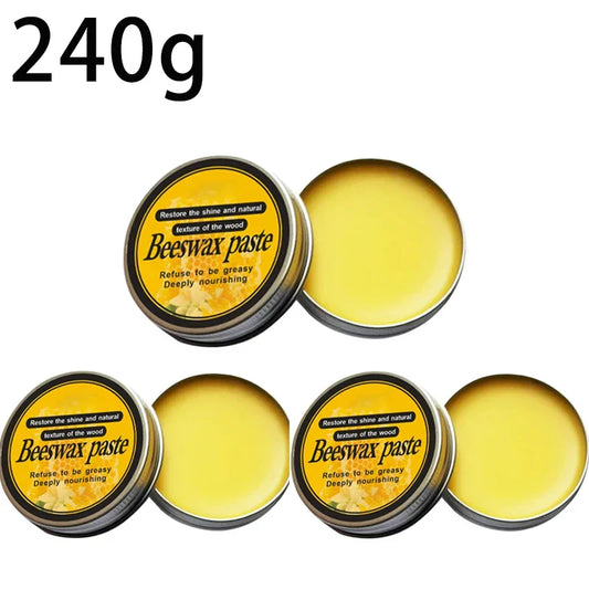 Yellow beeswax furniture polish paste in round metal tins with black and yellow labels for wood floor maintenance and wood musical instrument care