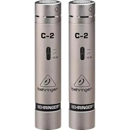 A pair of silver behringer c-2 matched condenser microphones with cardioid pickup pattern and low-mass diaphragm for studio recording