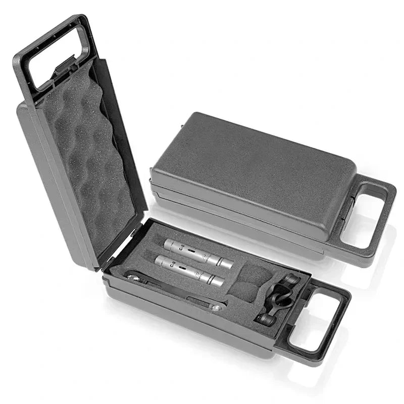 Black plastic carrying case with foam interior holding two silver behringer c-2 matched condenser microphones with cardioid pickup pattern and low-mass diaphragm
