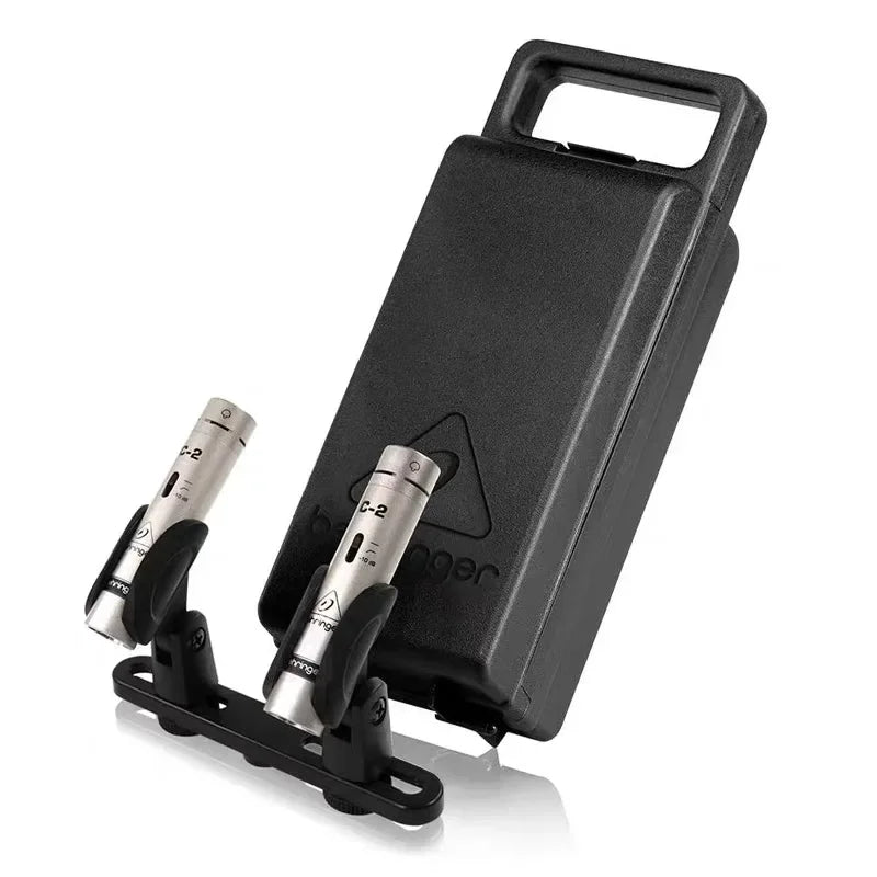 Black plastic carrying case with two silver behringer c-2 matched condenser microphones featuring cardioid pickup pattern and low-mass diaphragm