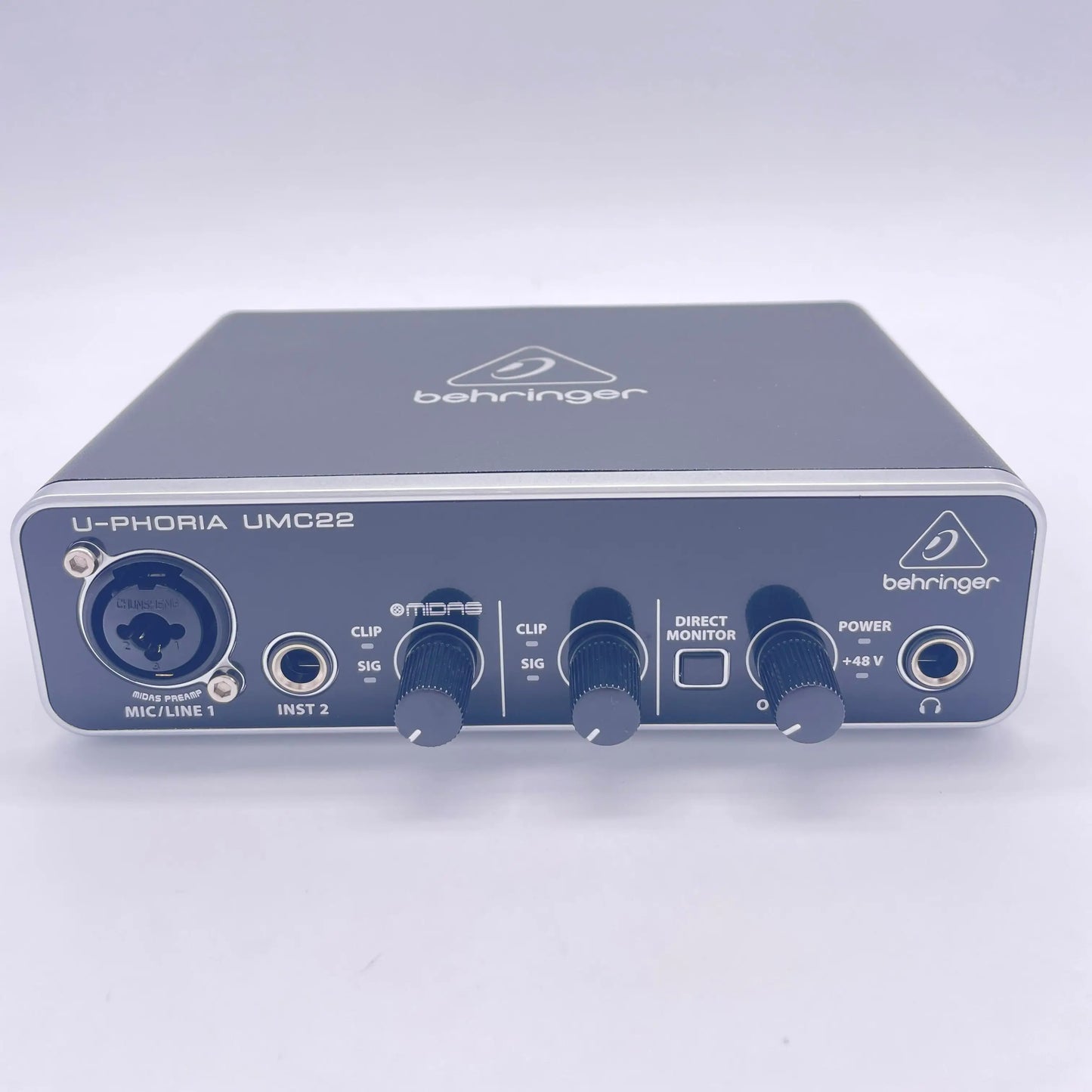 Black behringer umc22 sound card audio interface with silver trim and multiple input output ports for recording