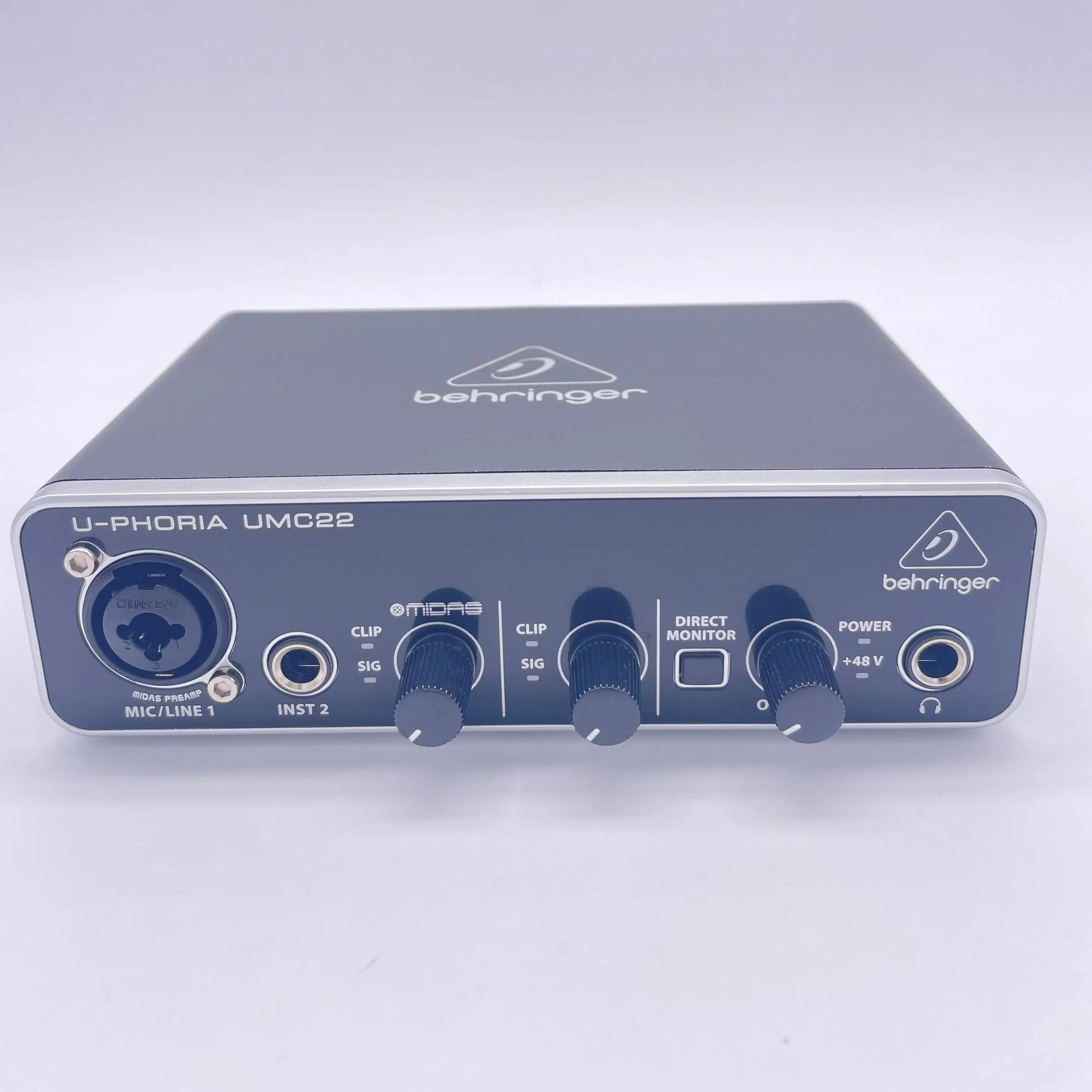 Black behringer umc22 sound card audio interface with silver trim and multiple input output ports for recording