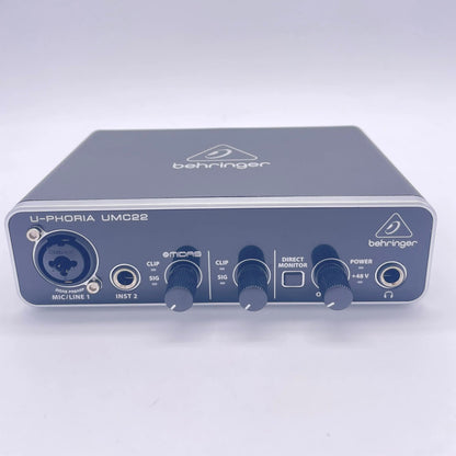 Black behringer umc22 sound card audio interface with silver trim and multiple input output ports for recording
