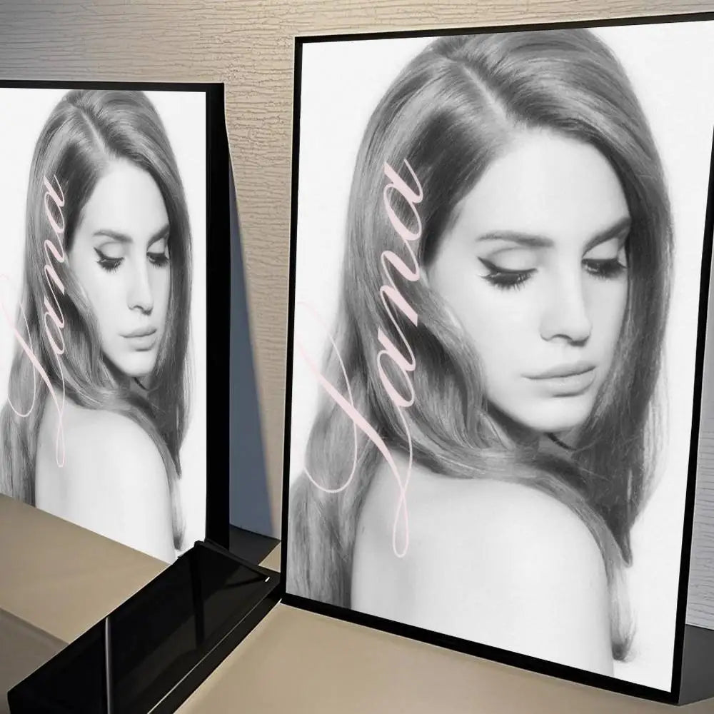 Black framed black and white lana del rey portrait art with white cursive name size reference for wall decor study
