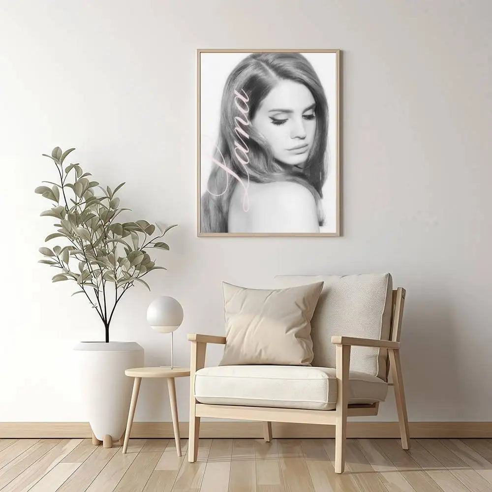 A framed black and white portrait of a woman with long hair in light wood frame size reference for nordic wall art