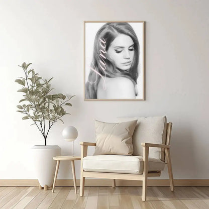 A framed black and white portrait of a woman with long hair in light wood frame size reference for nordic wall art
