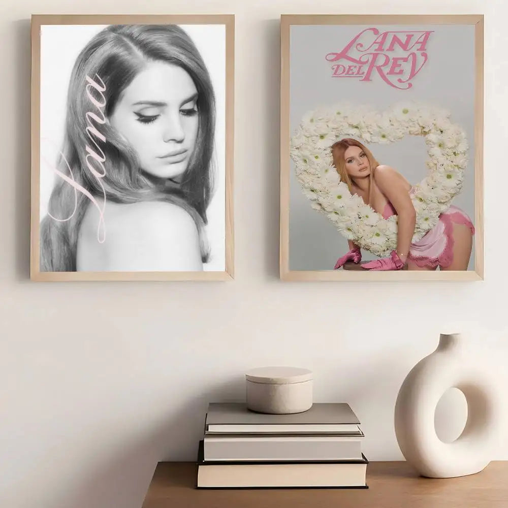 Two framed lana del rey posters featuring black and white portrait and vibrant pink floral heart with size reference