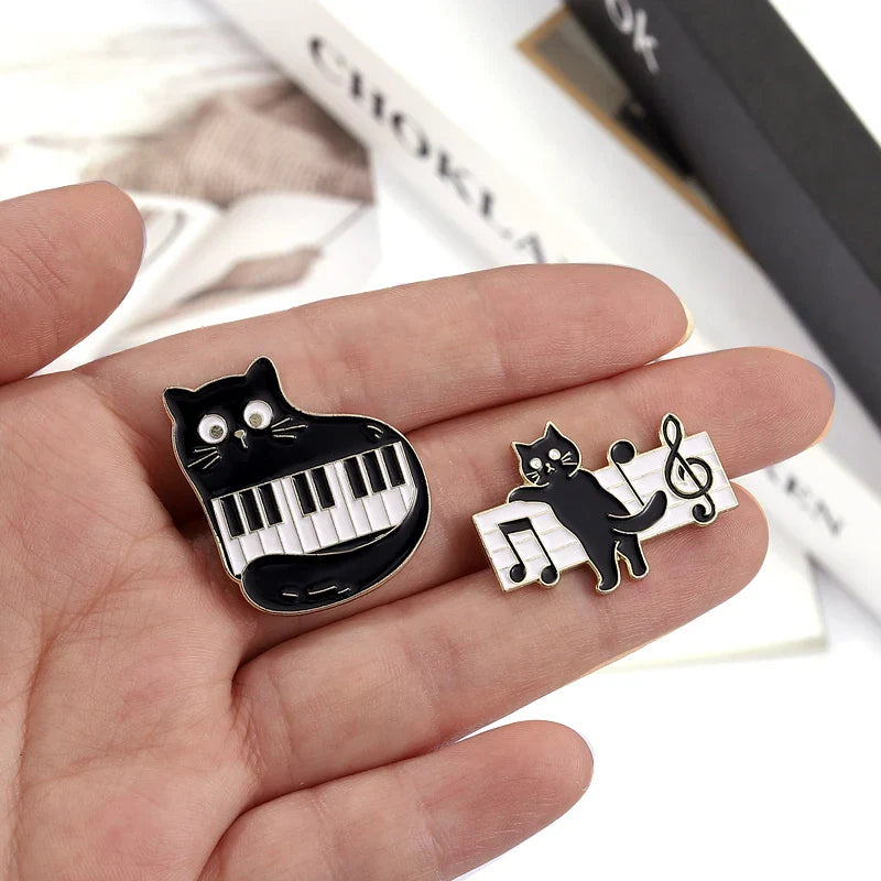 Black cat music enamel pin featuring piano keys and musical notes design animal cute musical piano brooch badge
