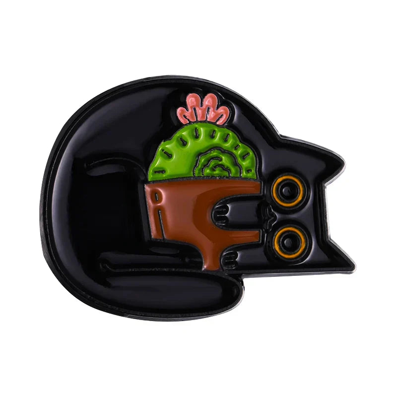 Black enamel pin of a black cat holding a green cactus with pink spines ideal as a piano brooch badge or animal cute musical accessory