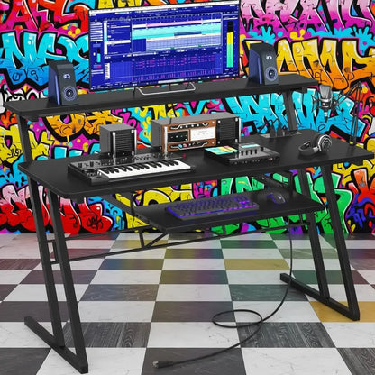 Black metal music production desk with two tiers and power outlet supporting monitor speakers and audio equipment