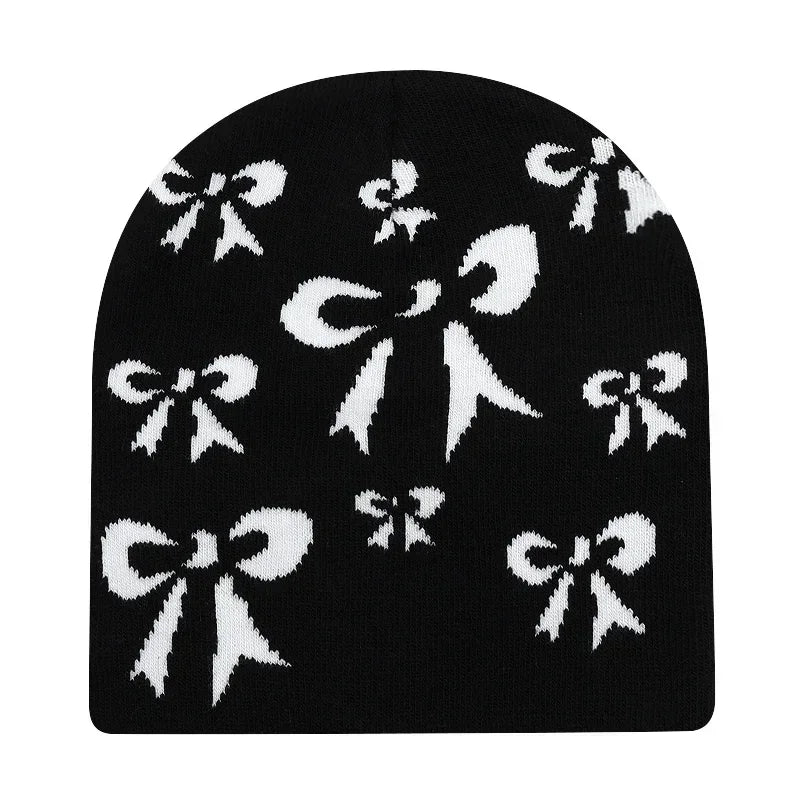 Black knit hat featuring a white bow pattern ideal as a warm beanies women option and skiing beanie outdoor accessory