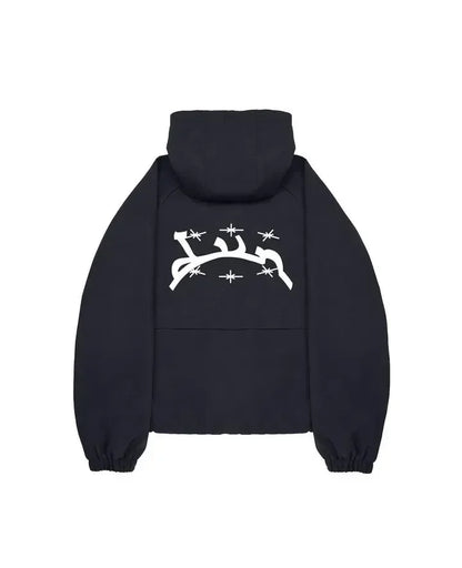 Black hooded sweatshirt with white arabic script and starburst graphics on the back in harajuku hip hop style