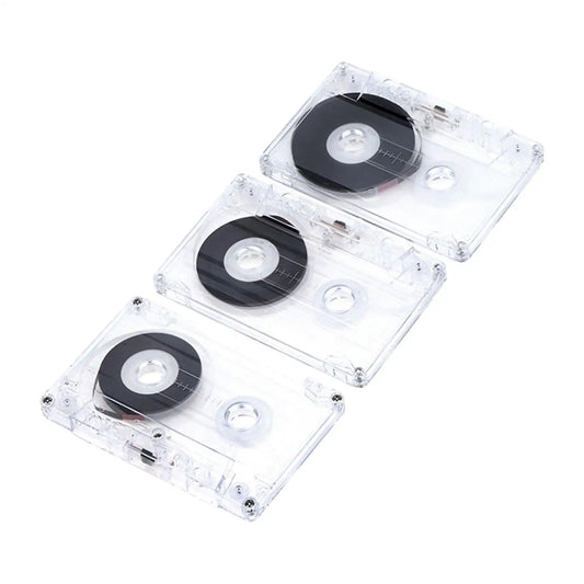 Three transparent blank cassette tapes with black spools and metal parts for professional audio cassette use in everyday voice memos and talking studio recording