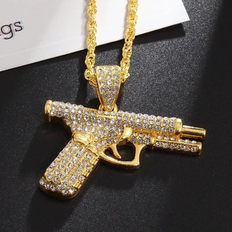 Gold-colored gun-shaped savage pendant cubic zirconia necklace adorned with clear crystals for rap party jewelry