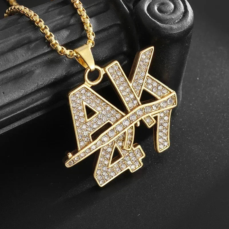 Gold-colored bold ak savage pendant cubic encrusted with clear rhinestones on a matching gold chain for rap party jewelry